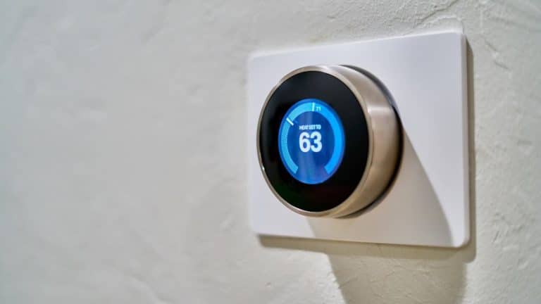 Smart thermostat mounted on the wall of a Texas home living room