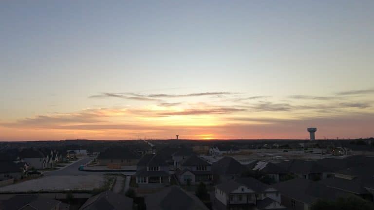 Texas suburban home with rooftop solar panels at sunset representing solar buyback plans
