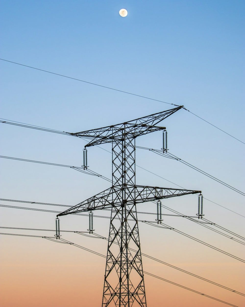Texas power lines under an evening sky illustrating the ERCOT 2 to 8 pm peak conservation window