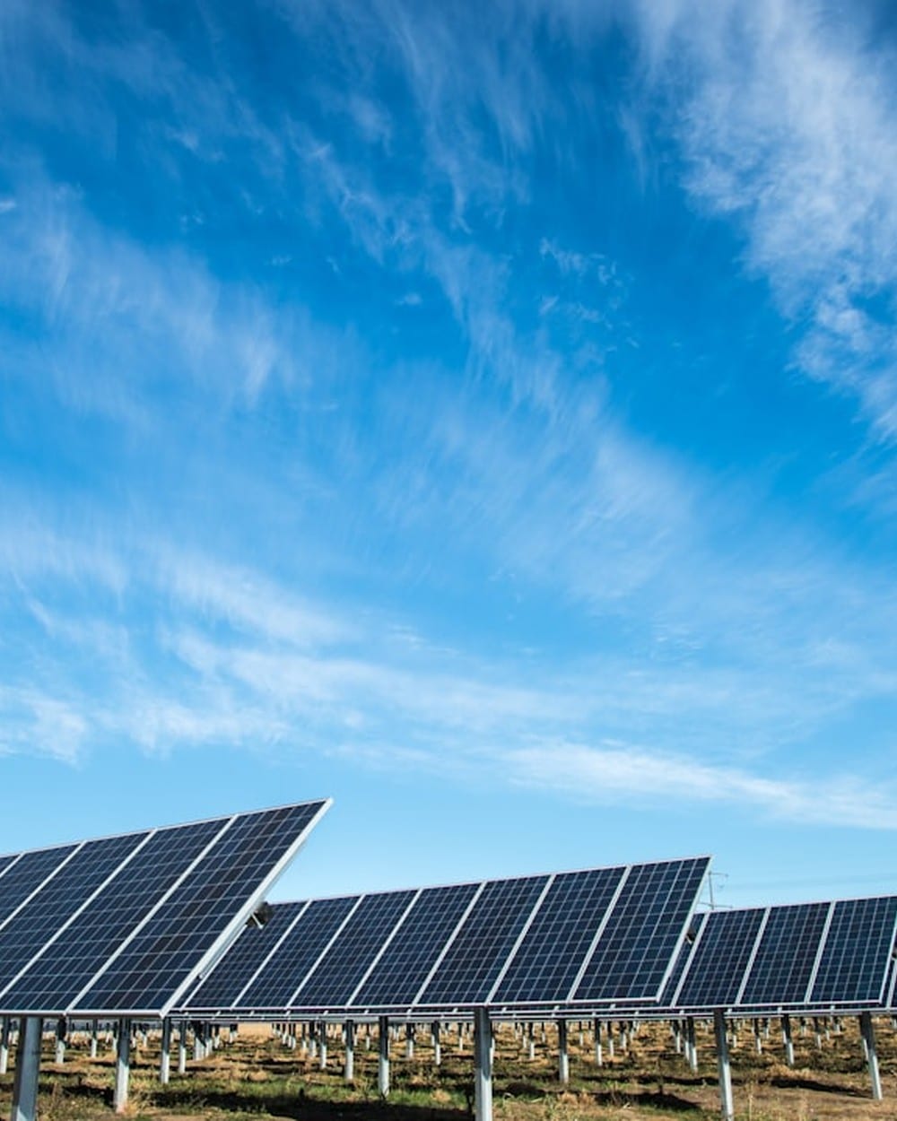 Solar panel array under blue Texas sky representing utility-scale solar buyback context