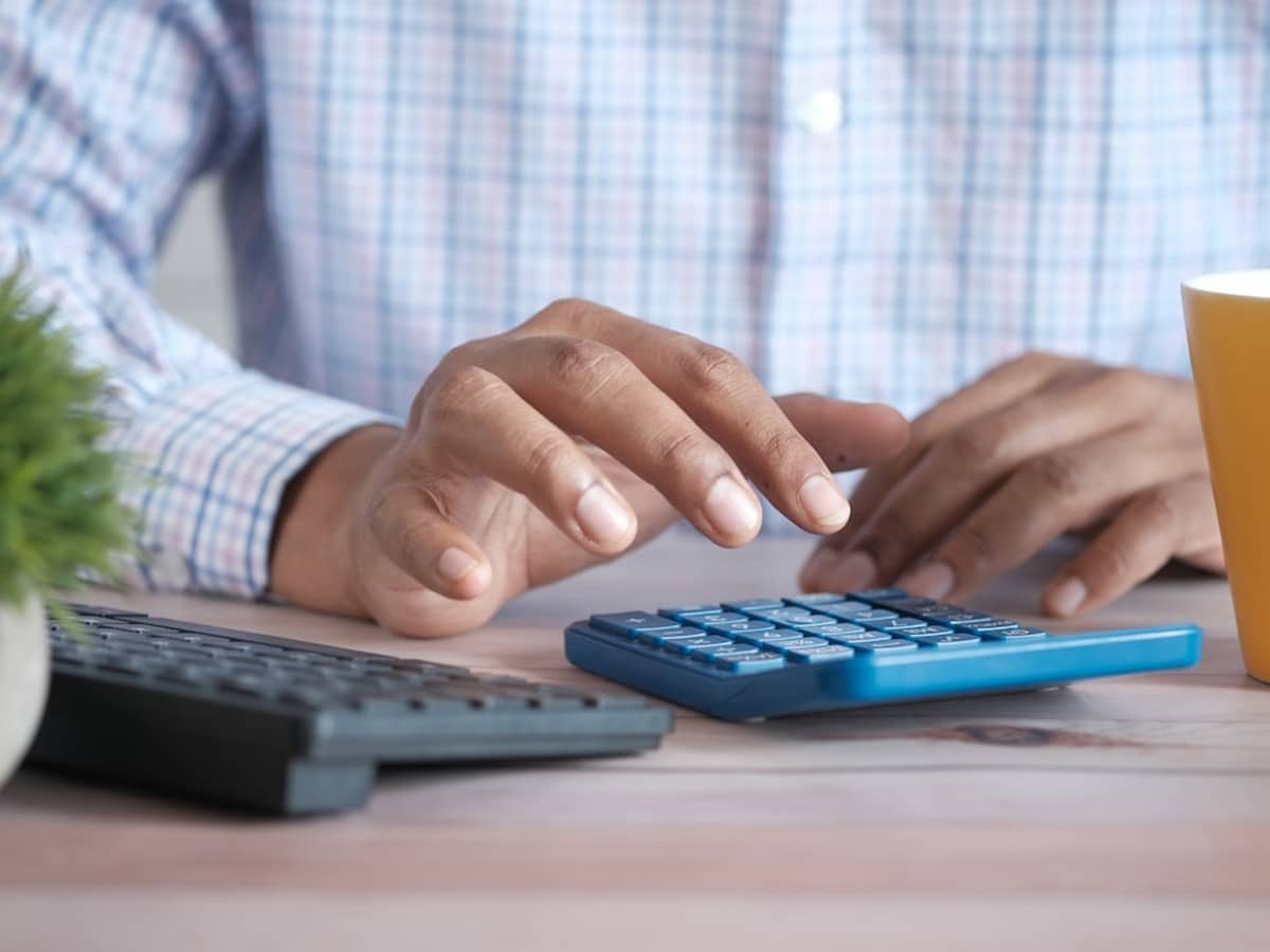 Calculator, notebook, and coffee cup showing a household running the free nights plan calculator math