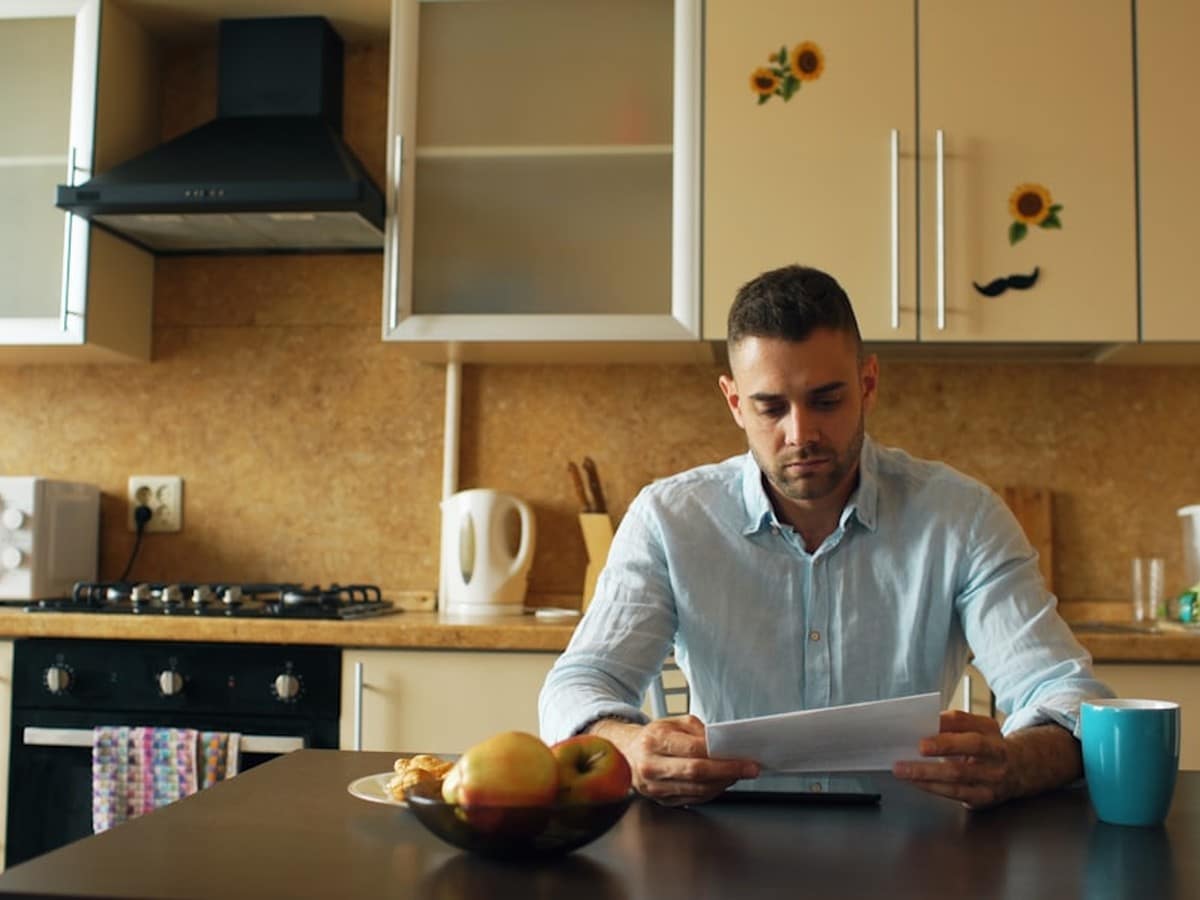 Texas homeowner reviewing an electricity plan and Electricity Facts Label at a kitchen table
