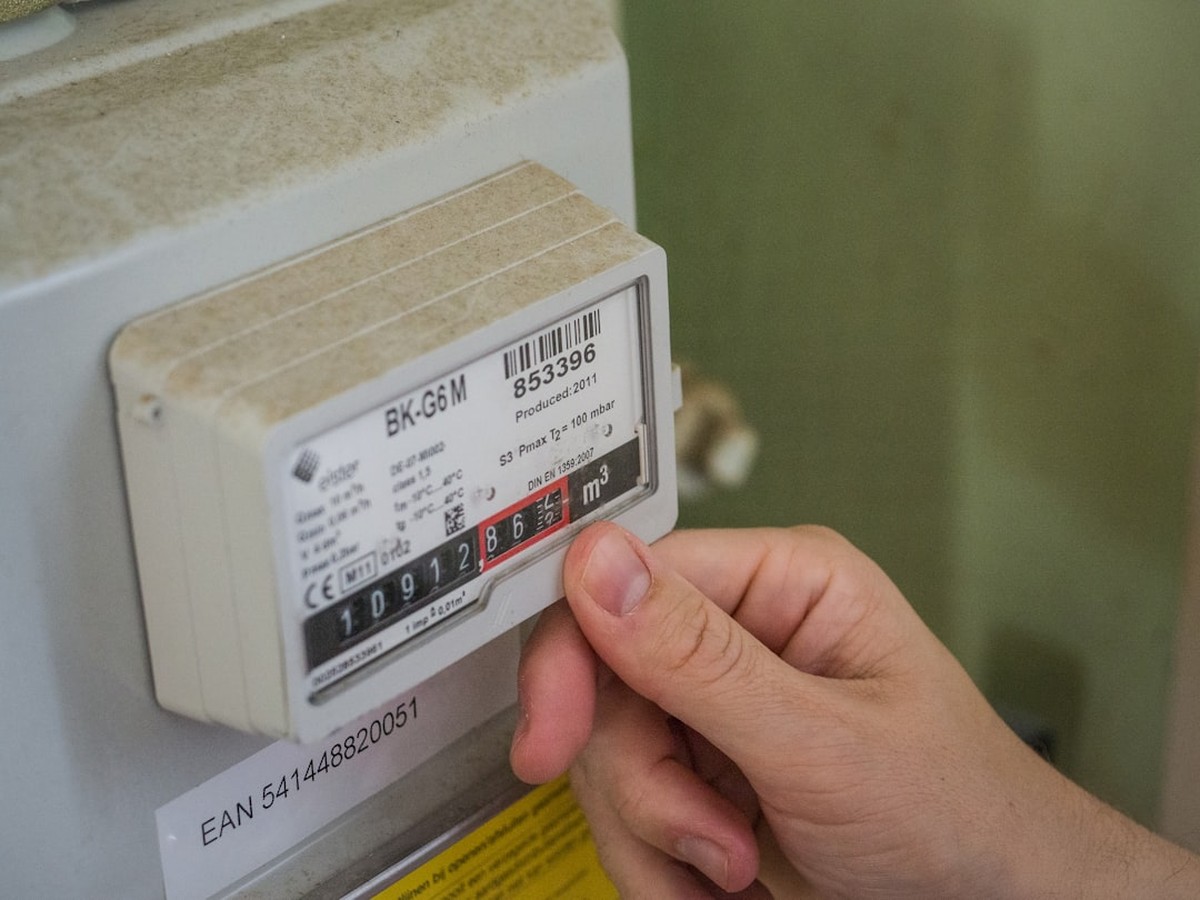 Hand holding a document representing a utility bill assistance application in Texas