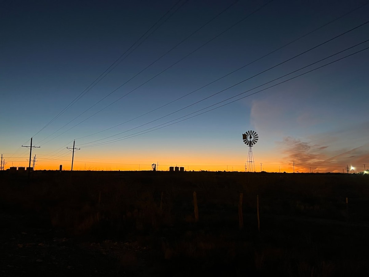 Texas wind turbines and transmission lines feed the ERCOT grid that sets residential electricity rates