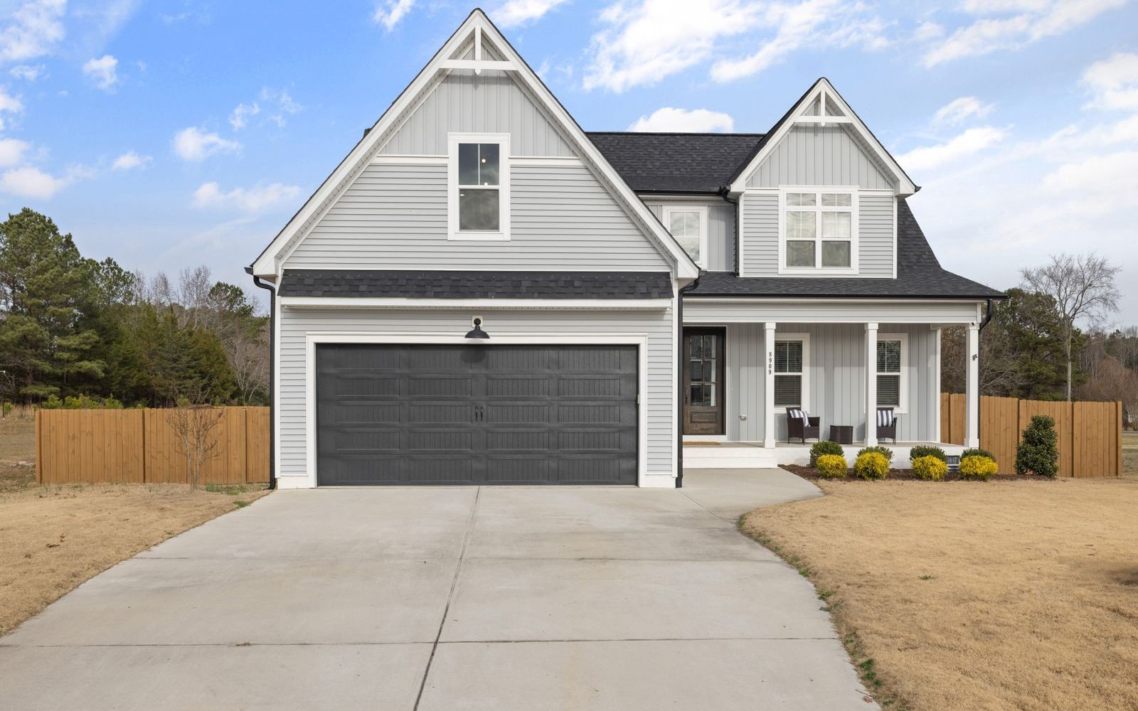 A suburban home in bright daylight with an empty driveway