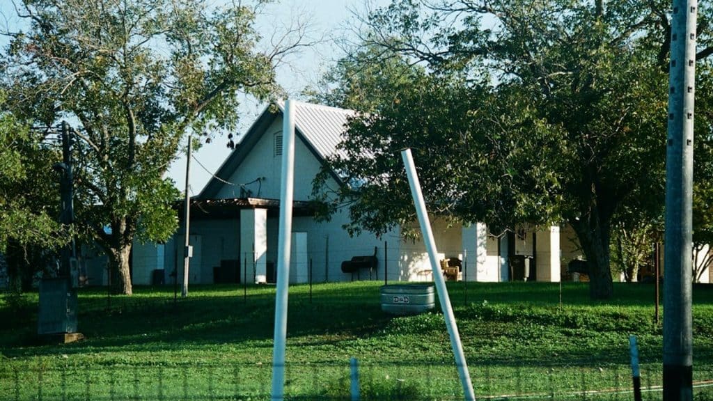 Texas home on a green lawn, illustrating a household weighing a free nights electricity plan