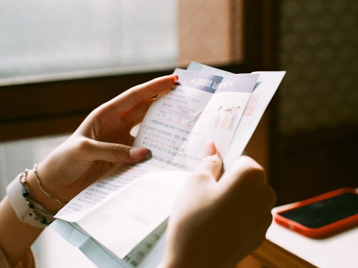 Person reviewing a residential electric bill statement showing delivery charges