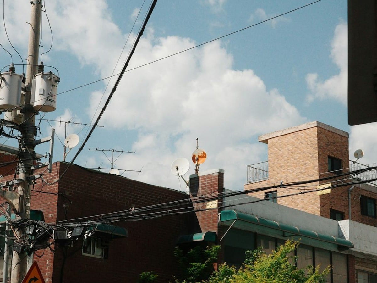 Urban street with distribution poles and power lines in a residential neighborhood