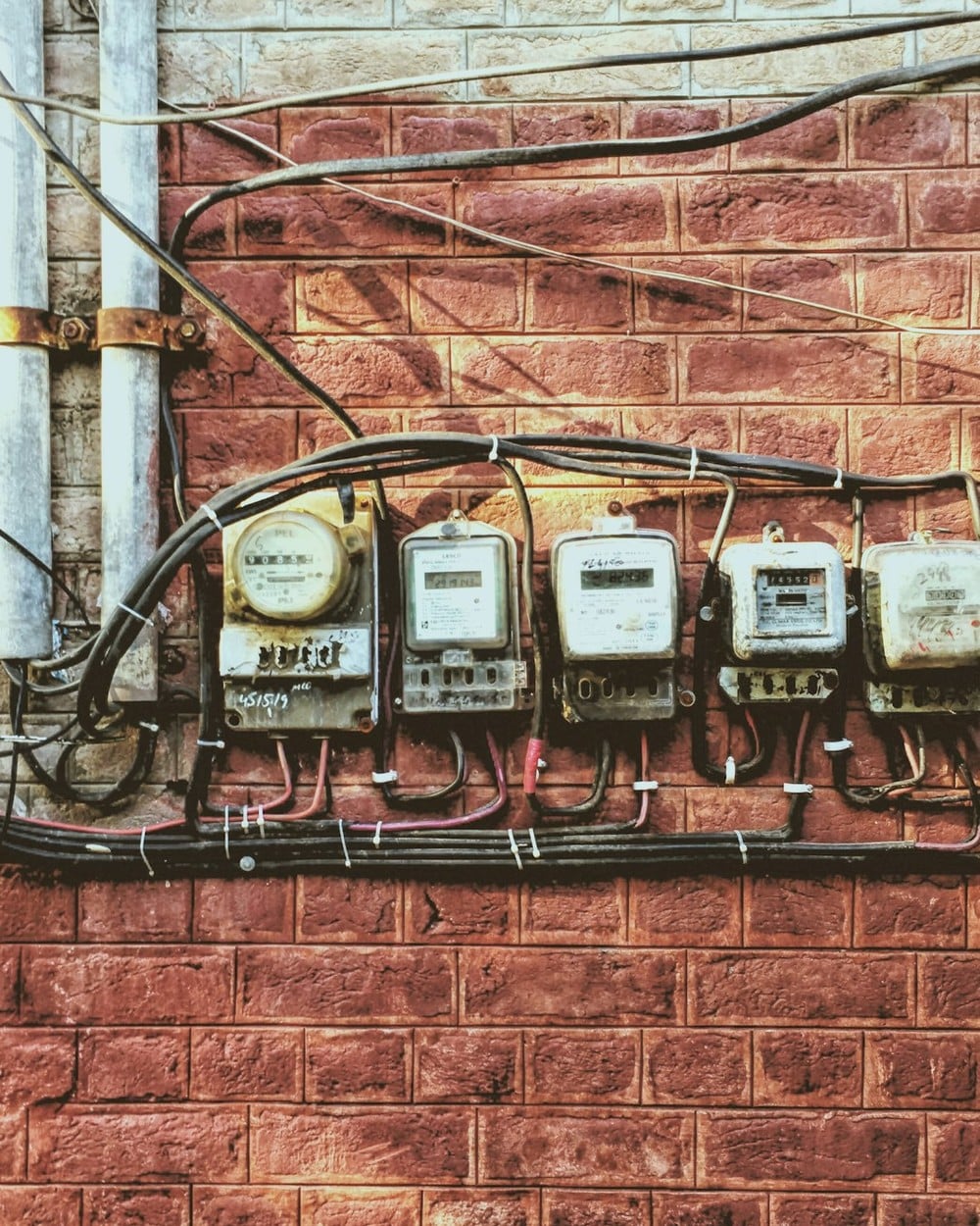 Row of residential electric meters on a wall, each billed the new LP&L monthly base charge