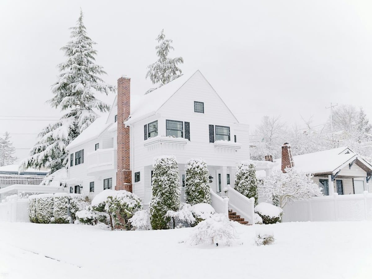 Houses covered with snow on a winter day, when electric heating pushes household usage up